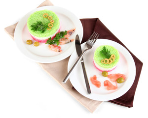 Colored rice on plates on napkin isolated on white