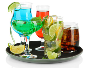 Many glasses of cocktails on tray, isolated on white