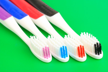 Tooth-brushes on green background