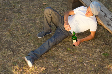 High angle view of an alcoholic man lying down