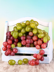 Ripe green and purple grapes in basket