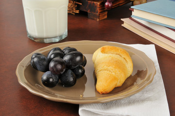 Croissant, grapes and milk