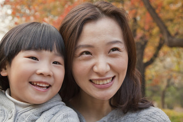 Close-up of Mother and Daughter smiling in the park, autumn, Portrait