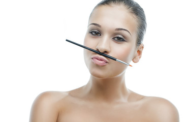 Fototapeta premium young woman doing make-up itself