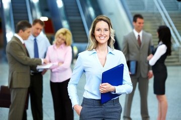 Obraz premium Business woman and a group of workers.