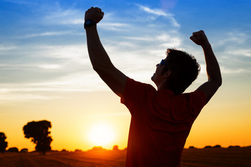 Sportsman with arms up celebrating success