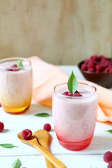 two glasses of raspberry milkshake