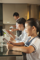 Family eating breakfast  and using digital tablet 