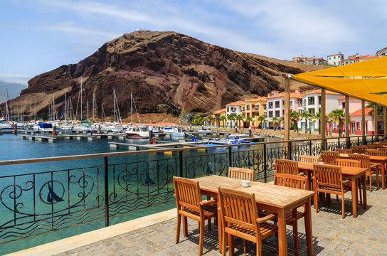 Chairs tables local restaurant in harbour, Madeira island