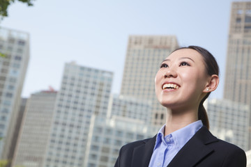 Young businesswoman outside among skyscrapers, Beijing