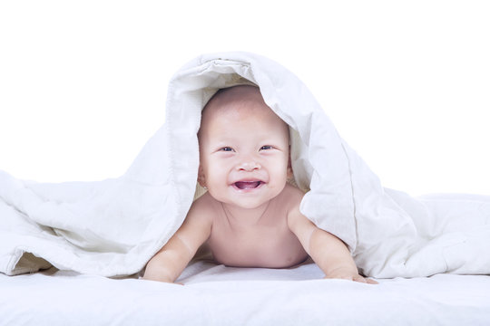 Baby laughing inside blanket - isolated