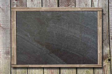 Blackboard on wooden wall background