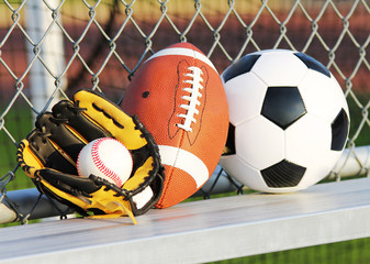 Sports balls. Soccer ball, football, baseball in glove. Outdoors