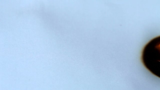 Burned hole on a white paper background