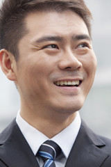 Young Businessman Smiling and Looking Away, Portrait