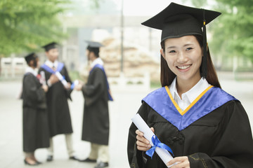 Young Female University Graduate, Portrait with Diploma