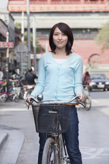 Fototapeta na wymiar Young Woman on a Bicycle in Beijing