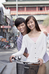 Fototapeta premium Young Heterosexual Couple on a Bicycle in Beijing
