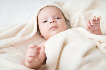 cute little baby hidden in blanket