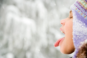 Girl in snow sticking out tongue - Powered by Adobe