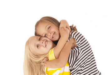 two young girls giving each other a hug