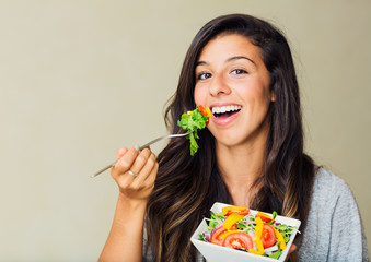 Healthy woman eating salad