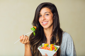 Healthy woman eating salad