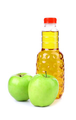 Apple juice in plastic bottle and two apples
