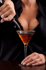 Barmaid mixing drink