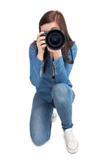 Pretty young photographer taking picture of camera