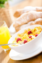 Close up view of plate with cereals and strawberry