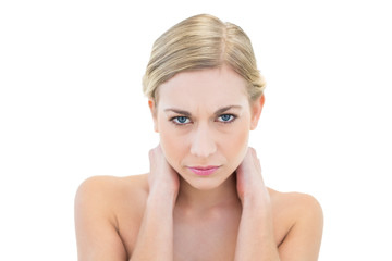 Irritated young blonde woman looking at camera