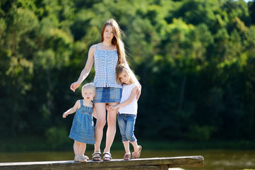 Naklejka premium Young mother and her two daughters