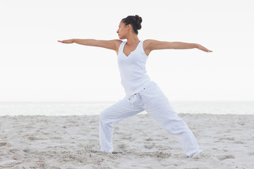 Fototapeta na wymiar Brunette woman stretching in yoga pose