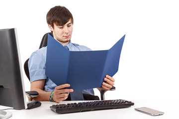 Young businessman in office checks contract