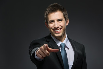 Portrait of pointing with forefinger businessman
