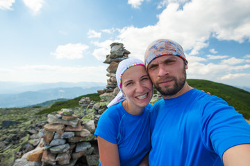 Caucasian couple takes rest on top of mountain