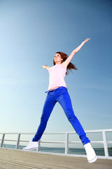 Fototapeta na wymiar Attractive girl Young woman jumping sky