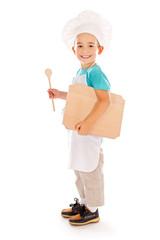 Happy little chef with wooden board and spoon