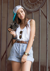 Beautiful woman with retro camera. Hipster style.