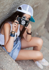 Beautiful woman with retro camera. Hipster style.