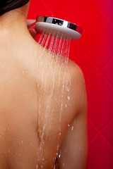 Beauty in shower. Rear view of naked young woman taking shower