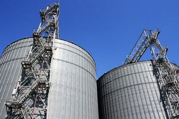 Grain storage place - metal containers against sky.