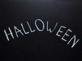 Fototapeta premium word halloween handwritten on chalkboard