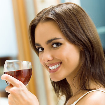 Young woman with glass of redwine
