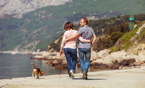 Love couple walking with beagle puppy