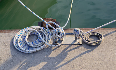 Old bollard with the rope