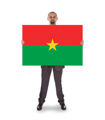 Businessman holding a big card, flag of Burkina Faso