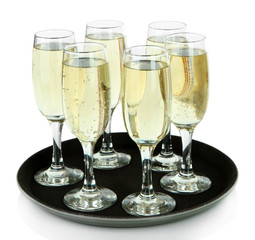 Many glasses of champagne on the tray, isolated on white