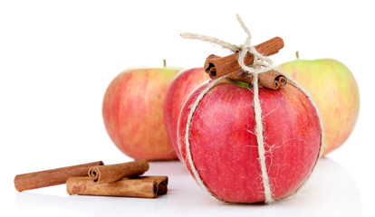 Ripe apple with with cinnamon sticks isolated on white